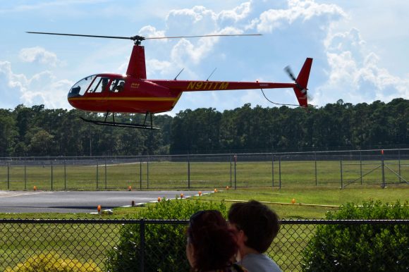 A bright red helicopter landing.