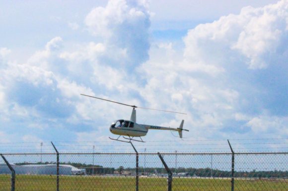 A white helicopter landing.